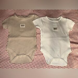 DKNY-NEW WITHOUT TAGS RIBBED BODY SUITS. SIZE 0-3 MONTHS. WHITE & BEIGE.